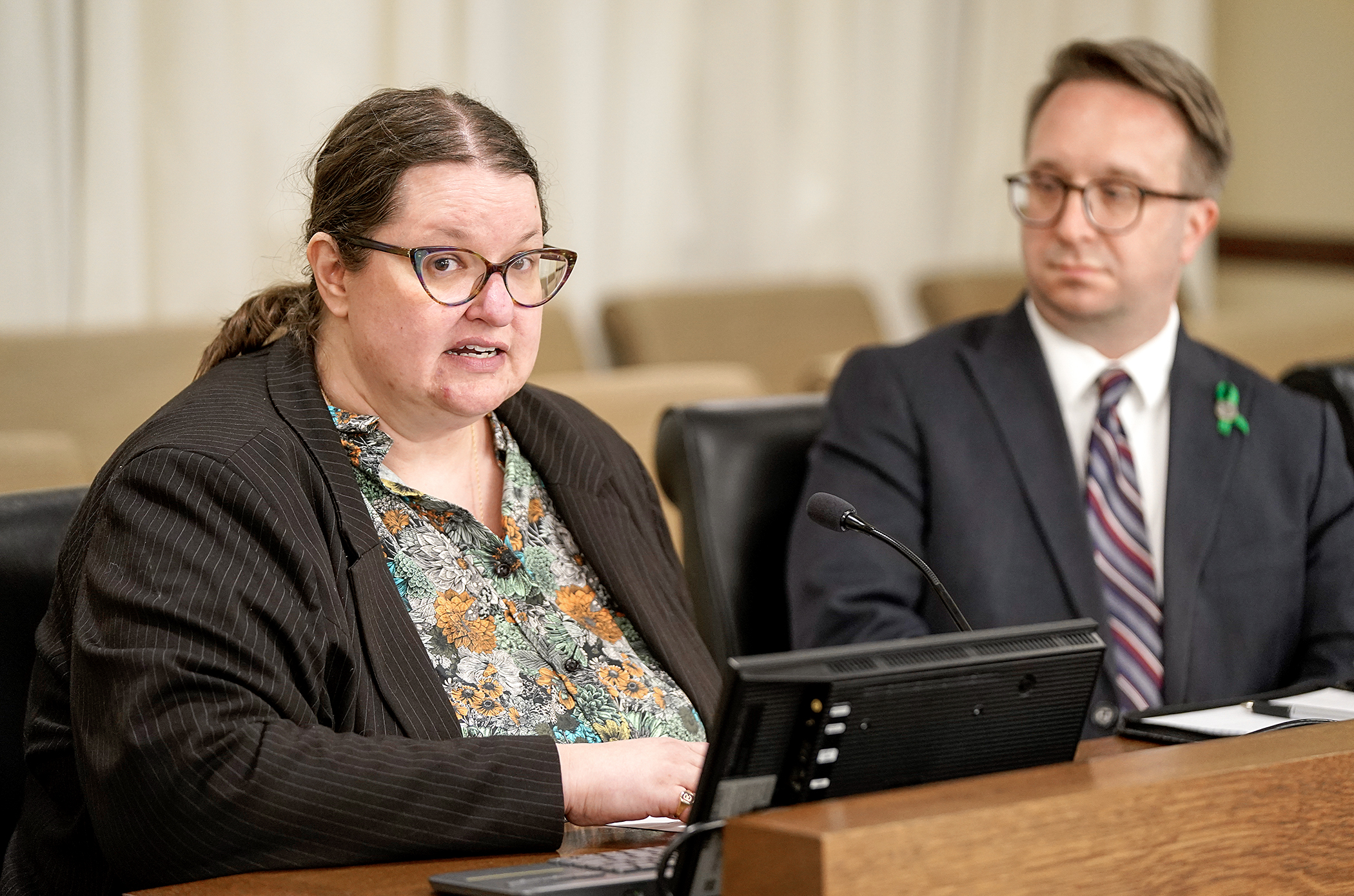 Inter Faculty Organization President Jenna Chernega testifies March 24 before the House higher education committee in support of HF4362, sponsored by Rep. Nathan Coulter, right. (Photo by Michele Jokinen)